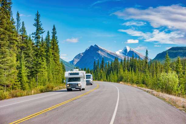 RV Canadian Rockies Alberta Canada motor homes RVs drive on Icefields Parkway in the Canadian Rockies, Alberta, Canada. canadian rockies stock pictures, royalty-free photos & images