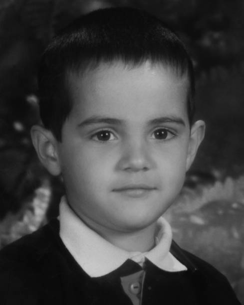 istock Smiling pensive little boy looking at the camera 1318716954