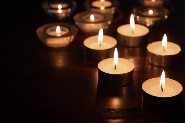 istock Group of Candles burning in the dark 1318717913