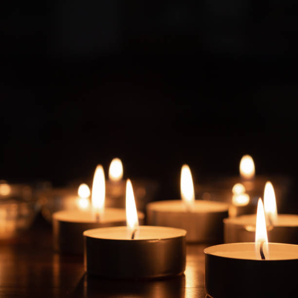 istock small candles burning in the dark 1318717917