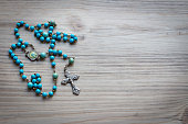Blue rosary on wood