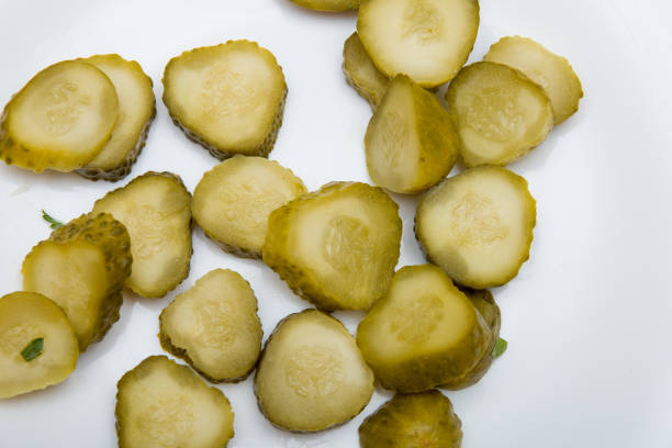 istock sliced pickled cucumber on a white background top view 1318718057