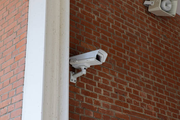 istock white security surveillance camera on a brick wall, side view, daytime, the system observes the surroundings and people who approach the building without authorization 1318720589