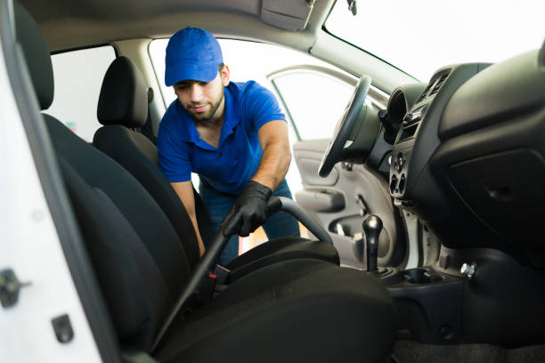 istock Young man vacuuming the inside of a car 1318721160