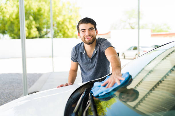 istock Handsome car owner cleaning his new car 1318721289