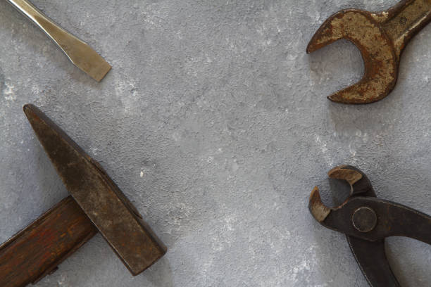 istock Hammer, wrench, gloves, and other worn and dirty tools on stone background with copy space. Father's day, DIY, home improvement, or labor day background concept. 1318722136