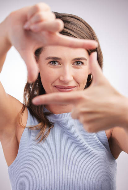 istock Studio portrait of a young woman making a finger frame against a grey background 1318722706