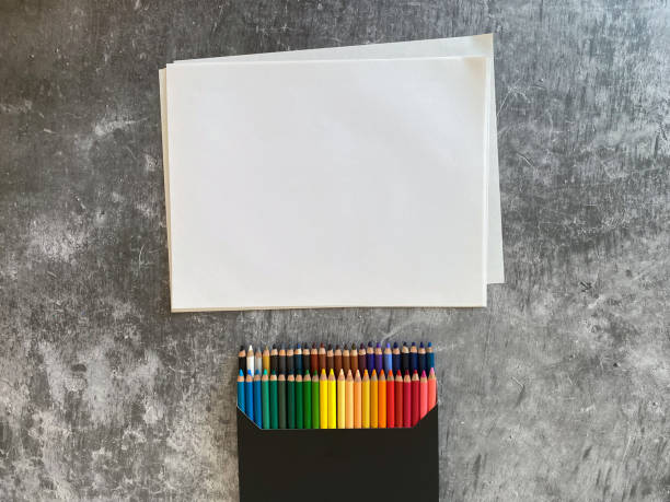 istock White sheets and a set of colored pencils to draw 1318728346