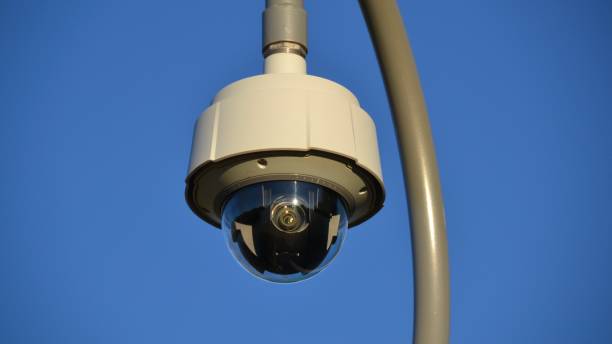 istock CCTV security or surveillance camera on a pole against a blue sky 1318730710