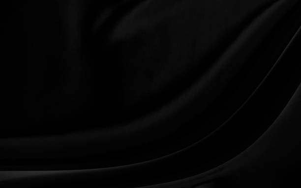istock Black gray satin dark fabric texture luxurious shiny that is abstract silk cloth background with patterns soft waves blur beautiful. 1318730713