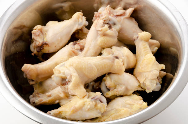 istock Boiled chicken drumettes in a stainless steel bowl on white background. 1318731108