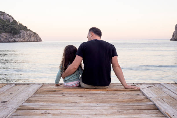 istock A father and his daughter spending some quality time together while sitting on a sea dock 1318733653