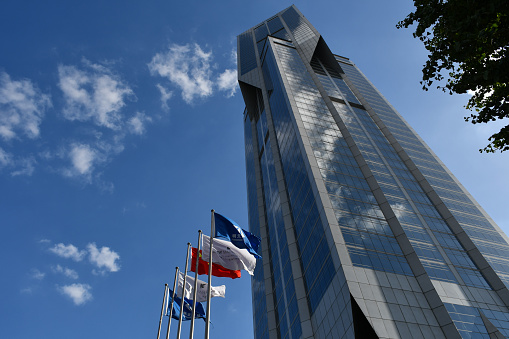 Shanghai, China - September 19, 2019: Tomorrow Square in Huangpu District, designed by John Portman and Associates, with flags of the JW Marriott Hotel Shanghai at Tomorrow Square, which it houses.