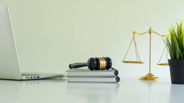 Judge Hammer and laptop and notebook with scales and flower pots on the desk. Judge Hammer and laptop and notebook with scales and flower pots on the desk. gavel keyboard stock pictures, royalty-free photos & images