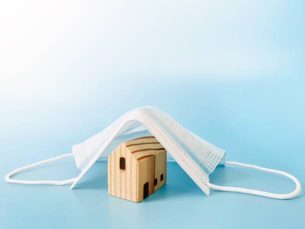 istock Wood house model cover by surgical mask with copy space ready for adding or mock up 1318736890