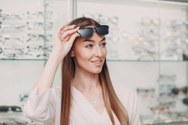 istock Young Woman with Black punched eyeglasses for vision training. perforated glasses trainer 1318737078