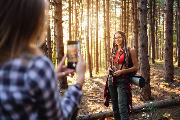 istock Cheerful girlfriends taking pictures with smart phone on their hike 1318737239