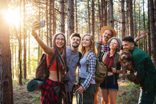 istock Smiling friends making selfie in the woods 1318737784