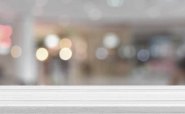 istock Empty white wood tabletop, desk over blur soft light in restaurant bokeh background 1318741504