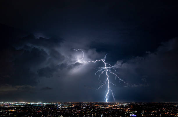 Massive Lightning Strike Over the Brisbane City Suburbs Lights What is lightning? Is it electricity being discharged from a build up of static in the clouds, or is it a sign from above of someone trying to plug in their hair straightener, and they can only find power outlets on the ground? I guess we'll never know. thunderstorm stock pictures, royalty-free photos & images