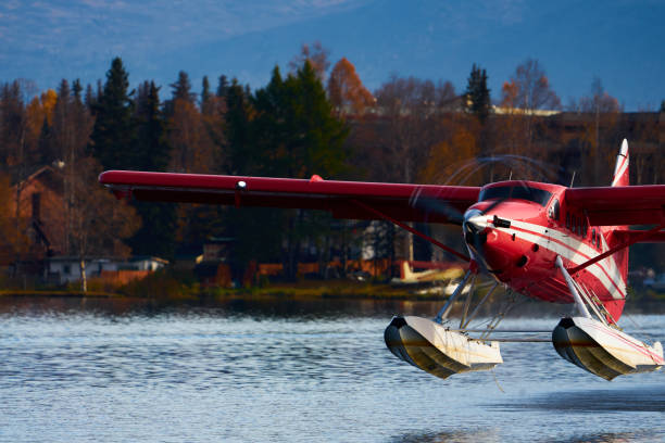 Otter Taking off from a lake This is a horizontal, color photograph of a sea plane taking off from Lake Hood in Anchorage, Alaska. bush plane stock pictures, royalty-free photos & images