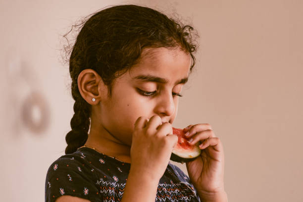 istock little girl eating watermelon 1318752706