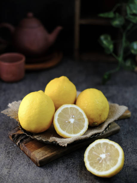 istock Fresh lemon fruits, lemon whole, half on the table 1318755325