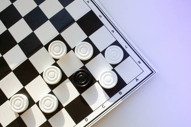 istock Board game of checkers. Black and white chips for the game. 1318760229