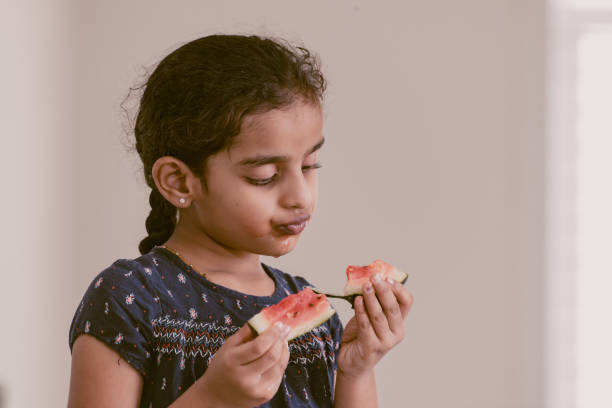 istock little girl eating watermelon 1318766435