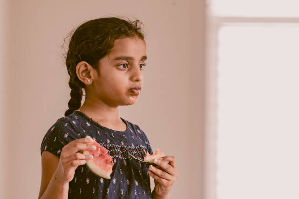 istock little girl eating watermelon 1318766505
