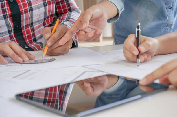 istock Architecture drawing on architectural project business architecture building construction Colleagues interior designer Corporate. Planning Design on blueprint Teamwork with compasses. 1318770941