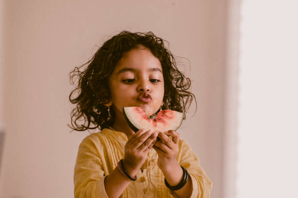 istock little girl eating watermelon 1318771123