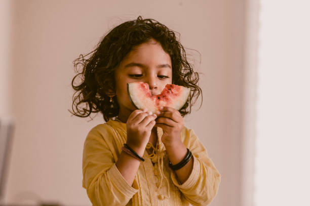 istock little girl eating watermelon 1318771125