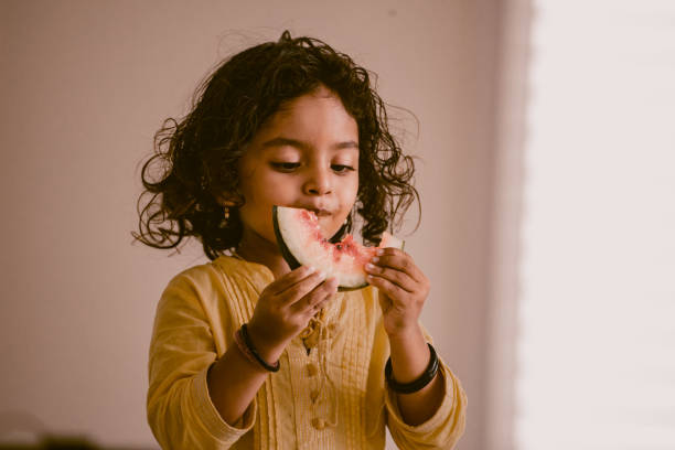 istock little girl eating watermelon 1318771397