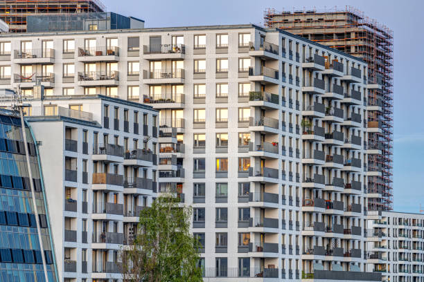 istock Big modern apartment building and the construction of another one 1318771475