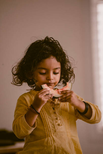 istock little girl eating watermelon 1318771603