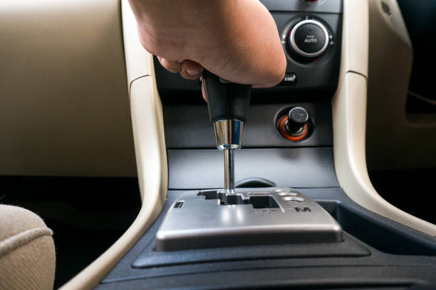 istock Man driving hands changing gear while driving in the car selective focus. safety driving 1318772606