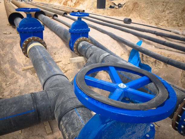 istock Valves on pipeline in ground. Pipe valves in trench 1318775665