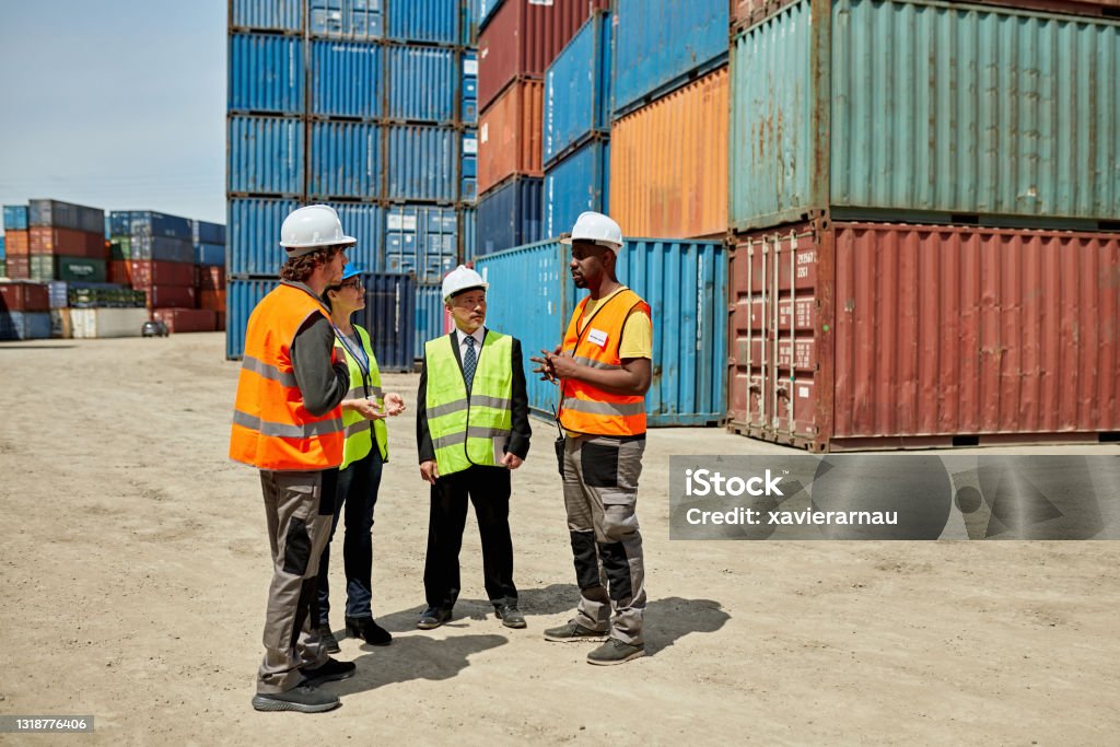 Otf Logistics Black Male Cargo Handler Talking With Logistics Team Stock Photo ...