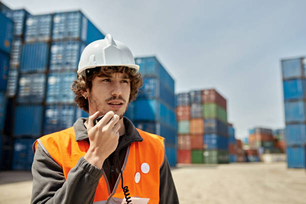 waist-up view of young male cargo handler at inland port - waistup stock-fotos und bilder