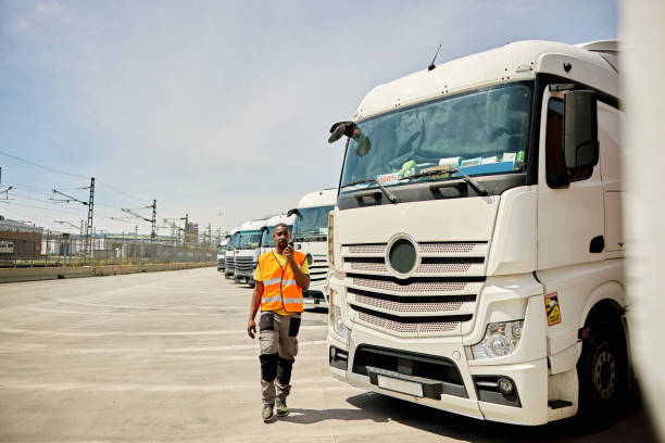 Mature Male Shipping Coordinator Using Walkie-Talkie