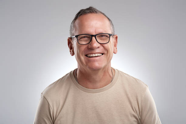 istock Shot of a handsome mature man standing alone against a grey background in the studio during the day 1318776663