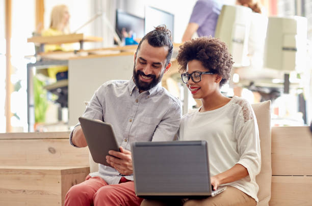 istock creative team with laptop and tablet pc in office 1318776755