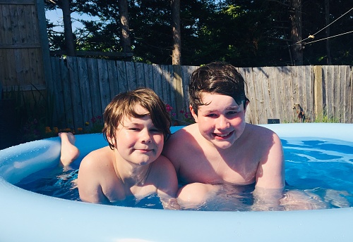 Boys in paddling pool