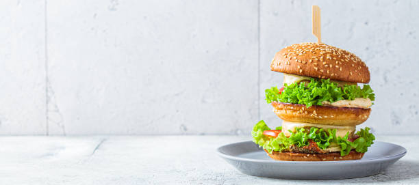 istock Banner with vegan cheeseburger on gray plate, copy space. 1318778058