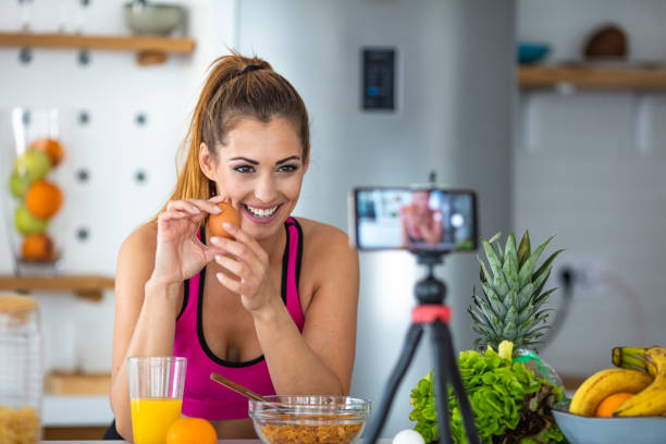 istock Young female blogger recording content for videoblog in Kitchen. 1318779131