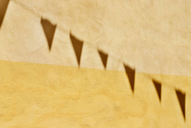 istock Shadows of  bunting flags on wall 1318779328