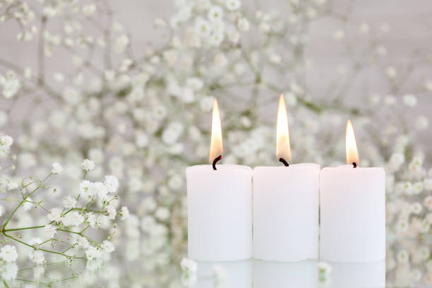 istock Burning candles and white flowers gypsophila on table with space for text. 1318780385