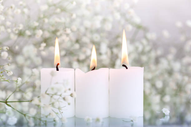 istock Burning candles and white flowers gypsophila on table with space for text. 1318780387