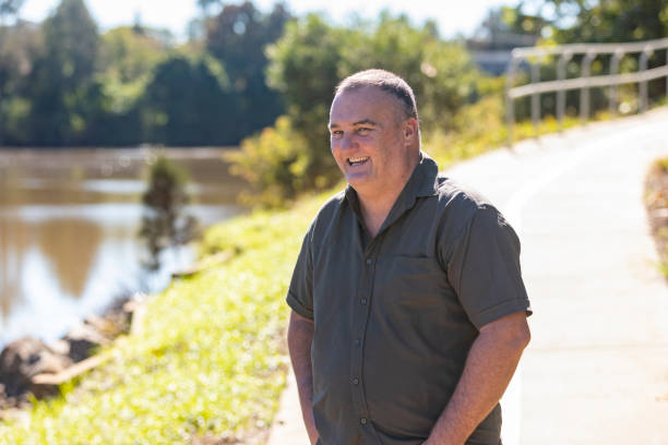 istock Happy Middle Aged Man Smiling by a River 1318783301